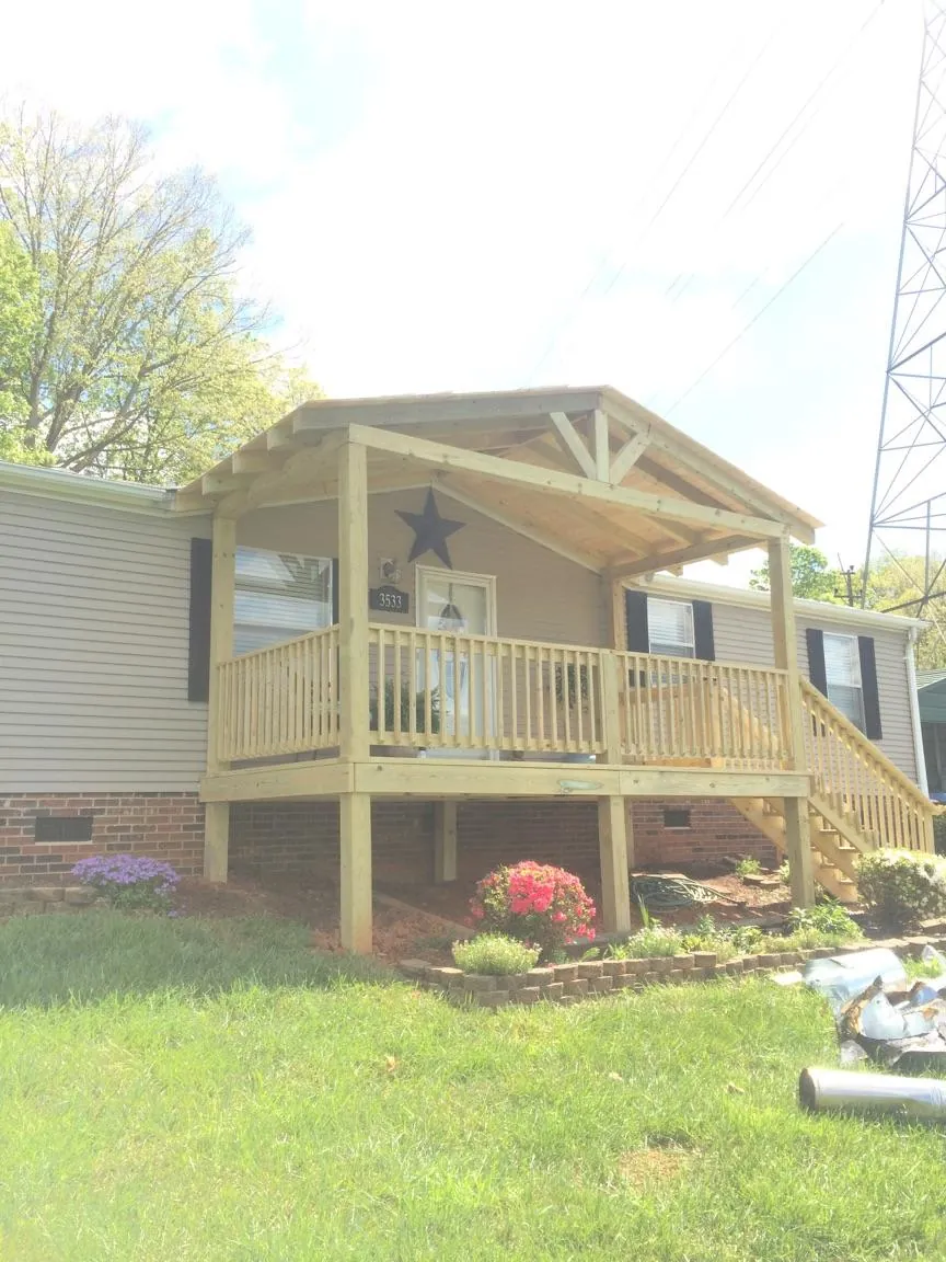 New gabled porch roof and deck railing added to a ranch home in Clarksburg